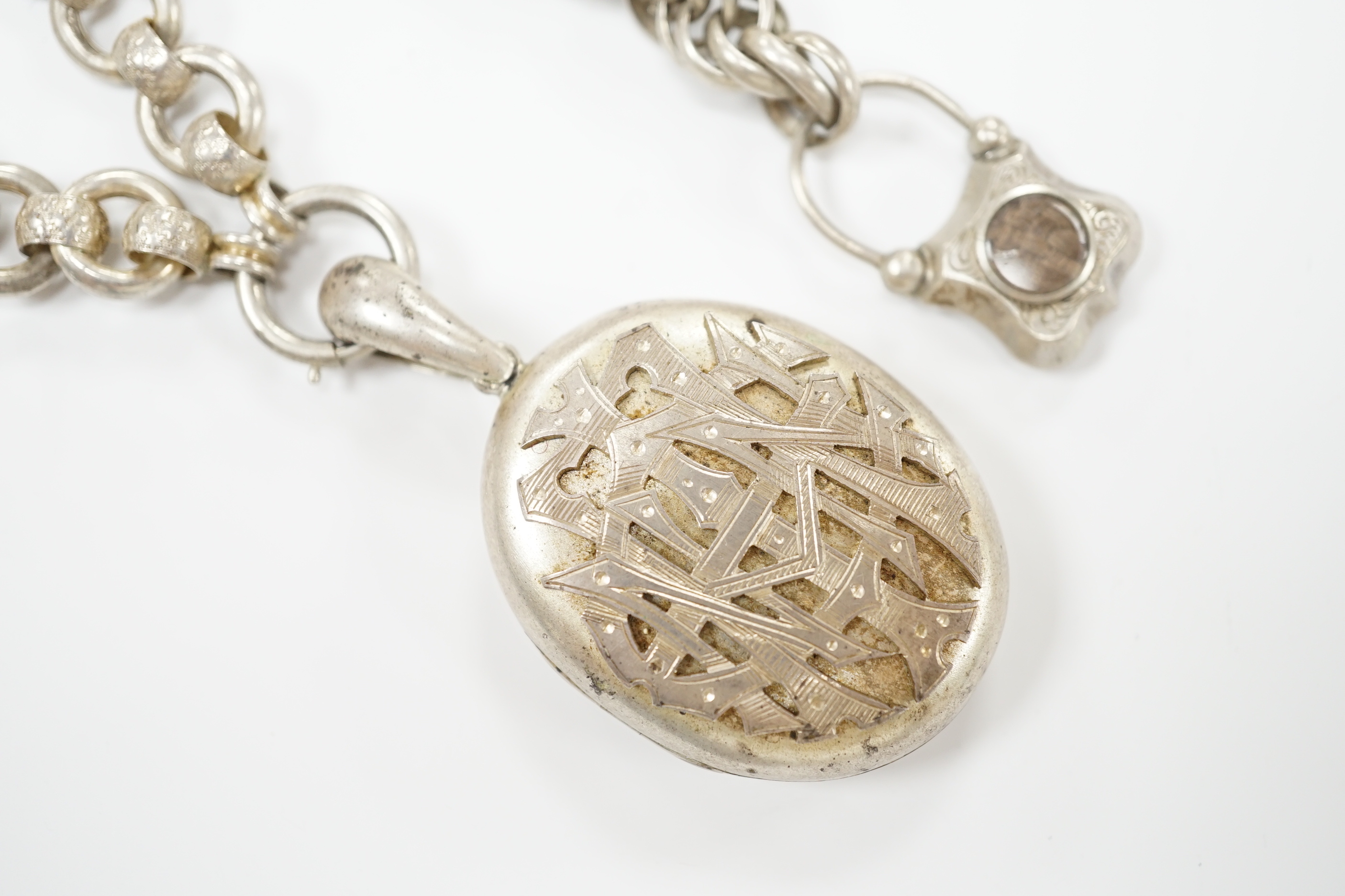 A Victorian white metal chains with a locket, a white metal bracelet and a sterling double heart shaped brooch.